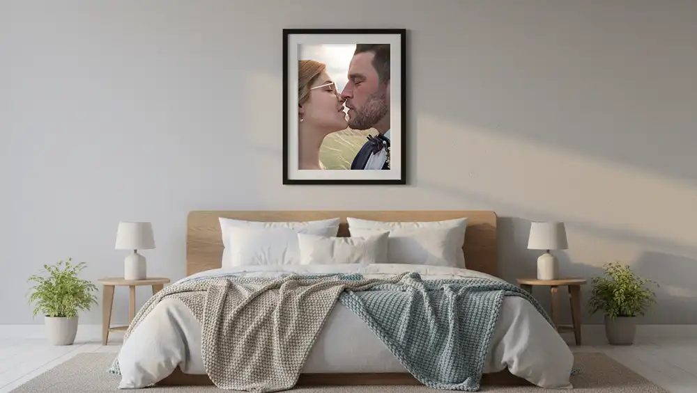 Image of a married couple kissing on the wall in a bedroom